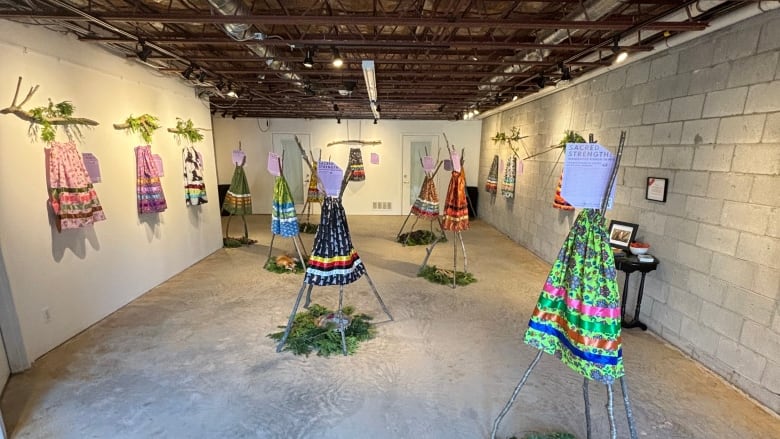 Indigenous ribbon skirts appear on display at a gallery.