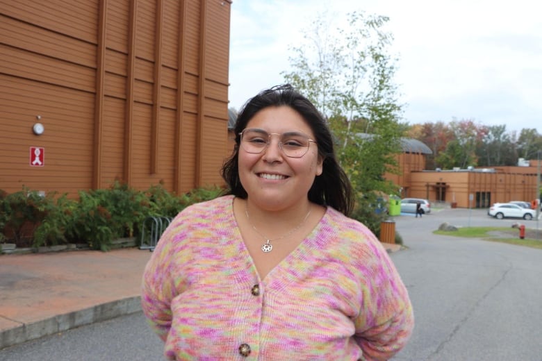 A woman smiles at the camera 