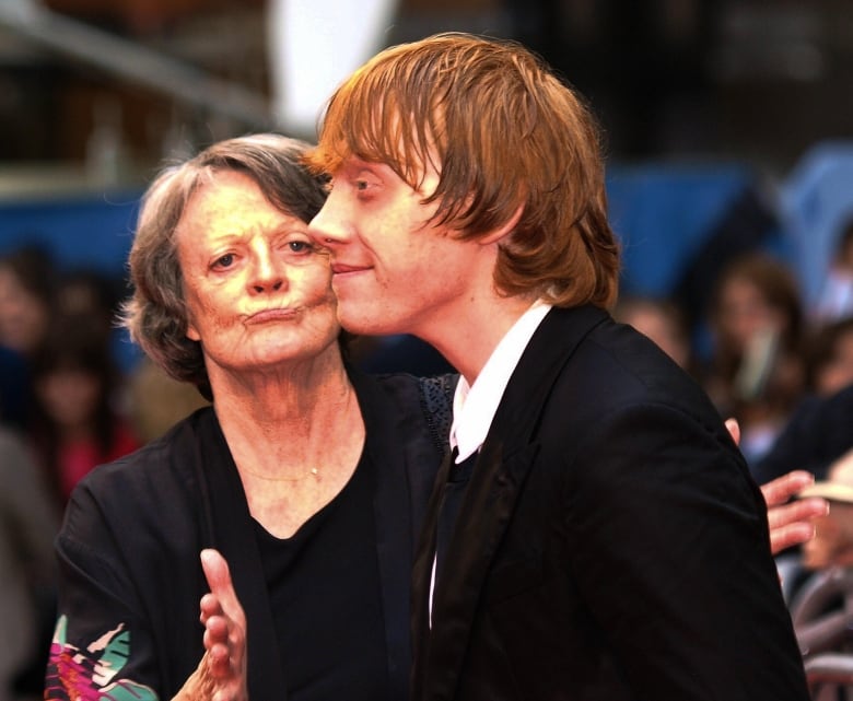 An older woman and young man on the red carpet