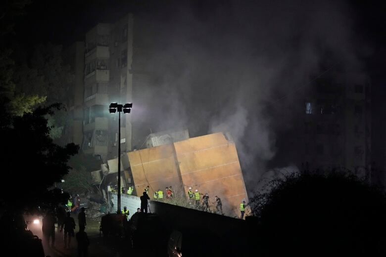 Smoke rises from a fallen building.