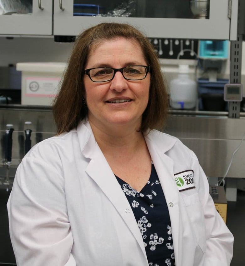 Mastromonaco, a woman withe brown hair, wearing glasses and a lab coat, is pictured in a lab space.