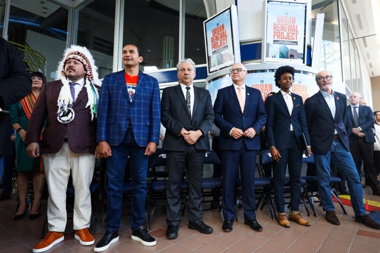 Politicians in blue blazers standing in a row.