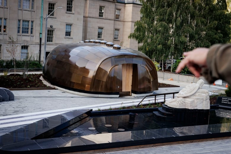 David Sherry, Dir. Toronto Council Fire, points towards the teaching lodge in the Spirit Garden installation in Torontos  Nathan Phillips Square, on Sept. 27, 2024. 