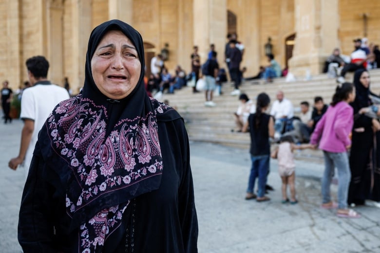 A woman reacts, among other displaced people, following the announcement of the death of Lebanon's Hezbollah leader Sayyed Hassan Nasrallah, in Beirut, Lebanon September 28, 2024. 