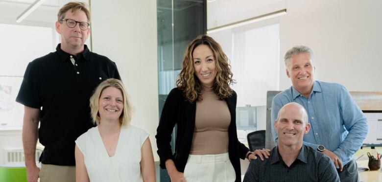 A group of people pose for a team portrait.