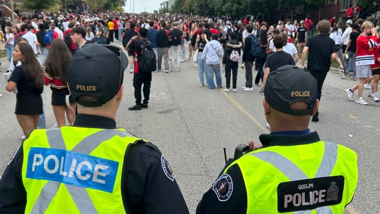 Photo of two police officers staring down a crowd. 