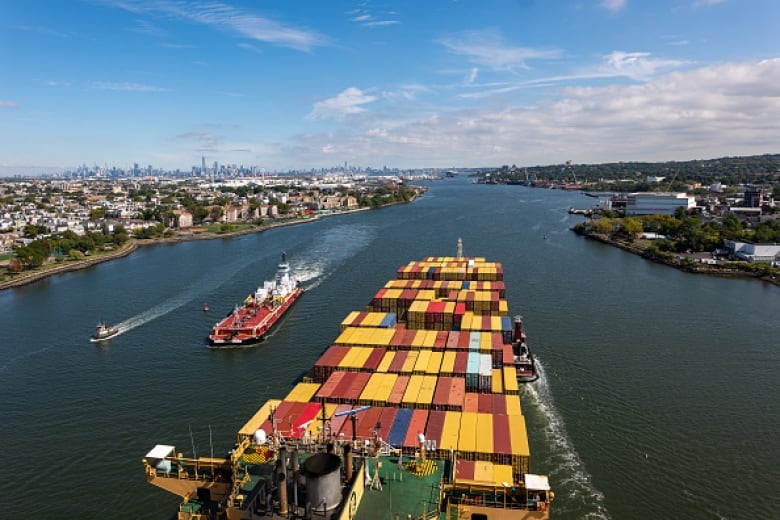 An aerial view of a ship carrying containers. 