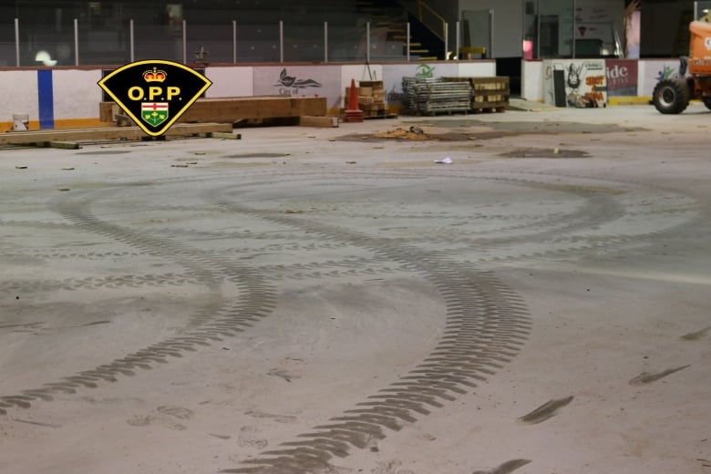 Traces of tires on the arena floor, seems dusty and dirty.