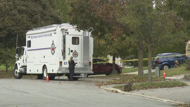 A police vehicle outside a suburban house