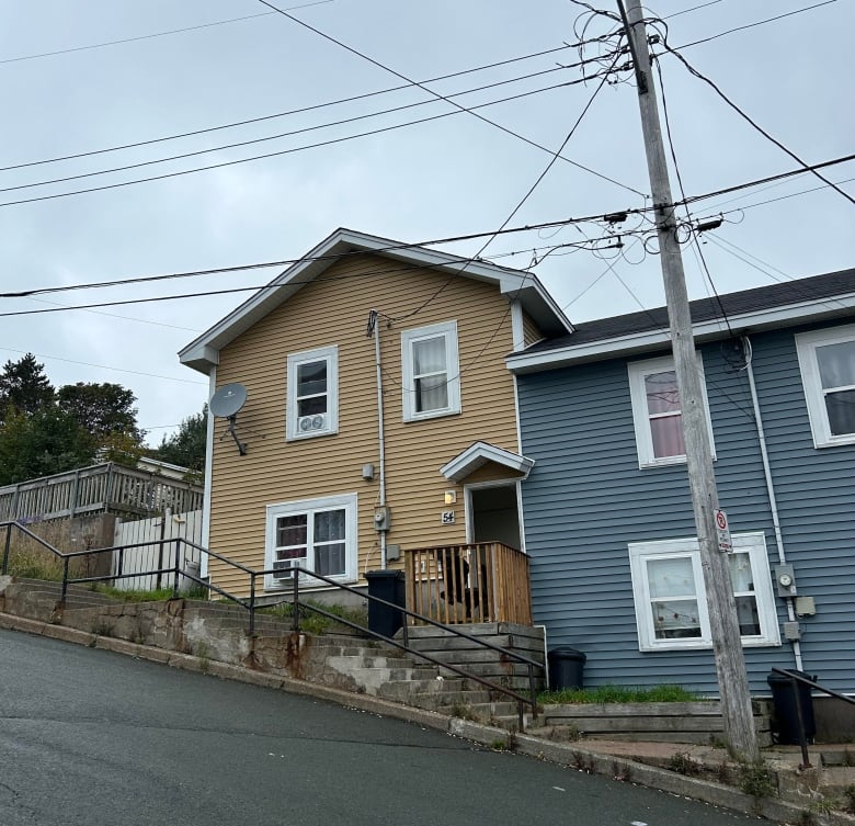 A house on a hill with dozens of concrete steps in either direction.