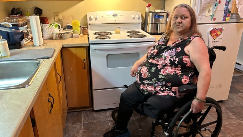 Whelan in a wheelchair in her kitchen.