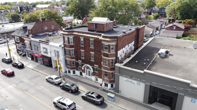 A brown brick apartment building seen from above. 