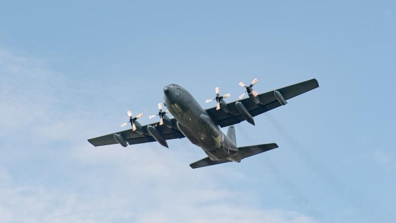 A photo shows a large airplane in flight.