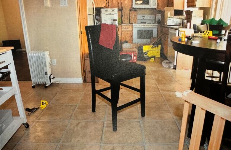 A messy kitchen scene with yellow evidence markers in various locations.