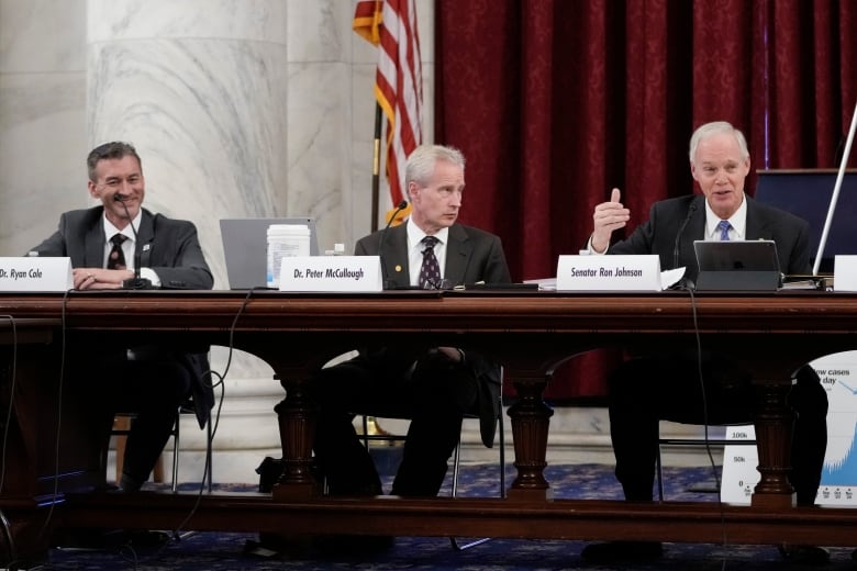 WASHINGTON, DC - JANUARY 24: (L-R) Dr. Ryan Cole, Dr. Peter McCullough look on as Sen. Ron Johnson (R-WI) speaks during a panel discussion titled COVID 19: A Second Opinion in the Kennedy Caucus Room of the Russell Senate Office Building on Capitol Hill on January 24, 2022 in Washington, DC. The panel featured scientists and doctors who have been criticized for expressing skepticism about COVID-19 vaccines and for promoting the use of unproven medications for treatment of the disease. (Photo by Drew Angerer/Getty Images)