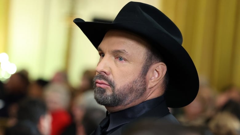 A close-up of the face of music star Garth Brooks, in a photo taken during a reception he attended at the White House in Washington, D.C., in December 2022.