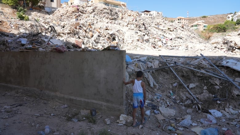 Abdul Basset's son amid the rubble of Ain el Delb