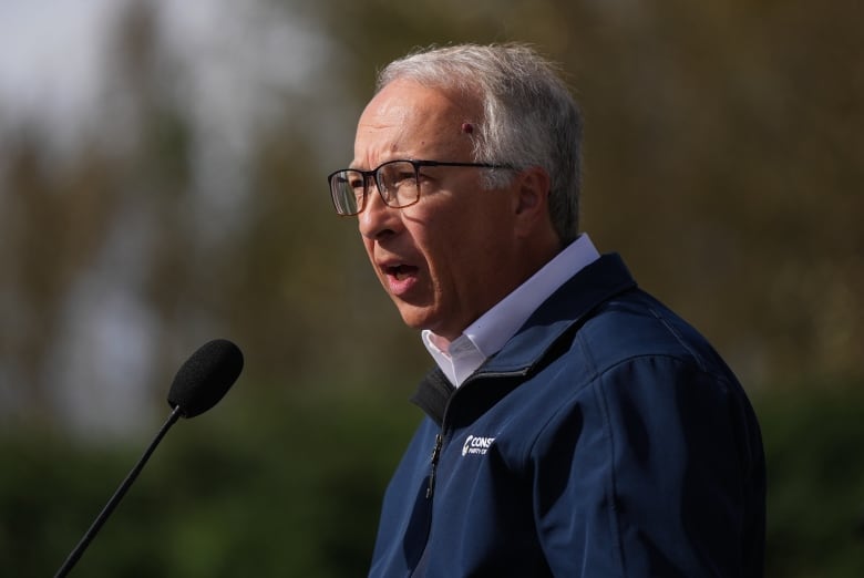 A white man is pictured in profile while speaking.