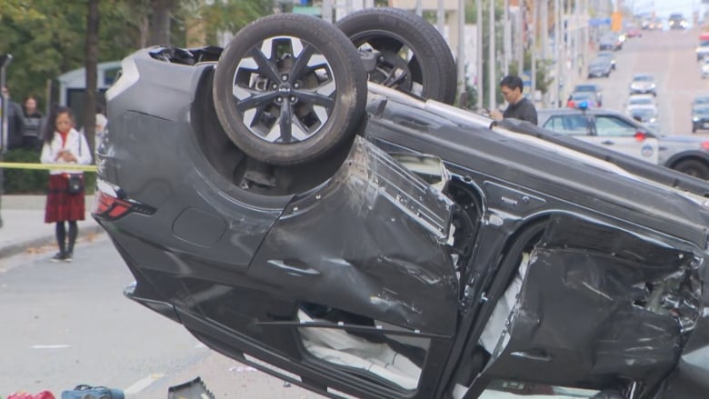 A close up view of the Kia passenger vehicle after it was rammed and shot at twice and after it flipped over on Monday.