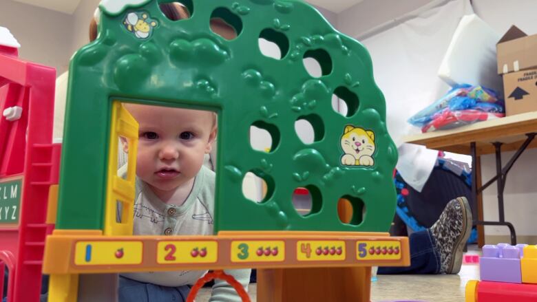 A baby plays with toys.