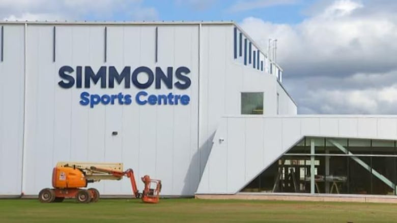 White building with words Simmons Sports Centre in blue letters