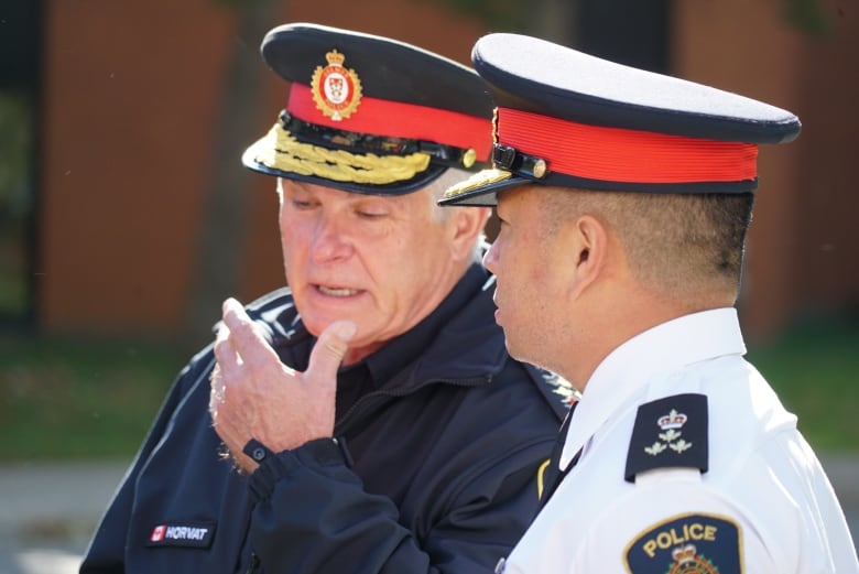 Zvanko Horvat, left, and Thai Truong, are the police chiefs of Aylmer and London, respectively. The two were among a number of local police officials present for Wednesday's announcement.