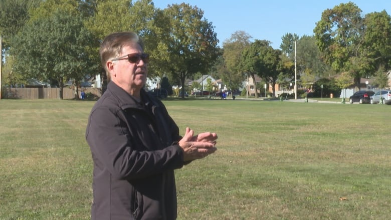 A man wearing sunglasses at a park.