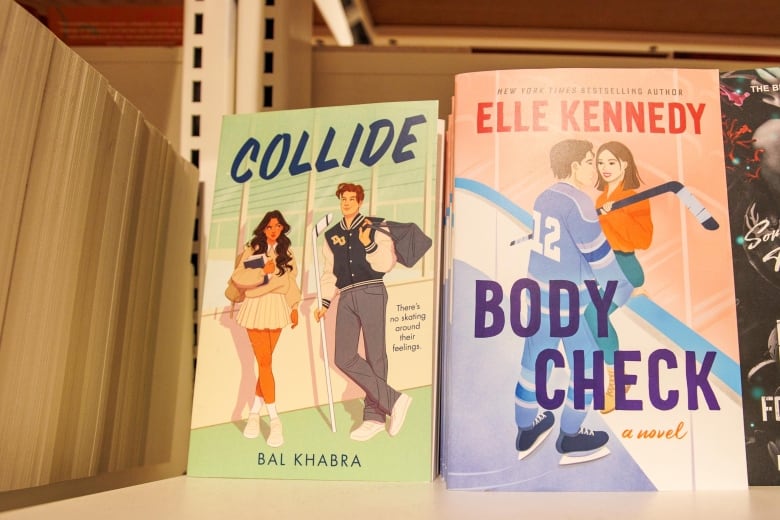 Two books on a book shelf, one called Collide, the other called Body Check.