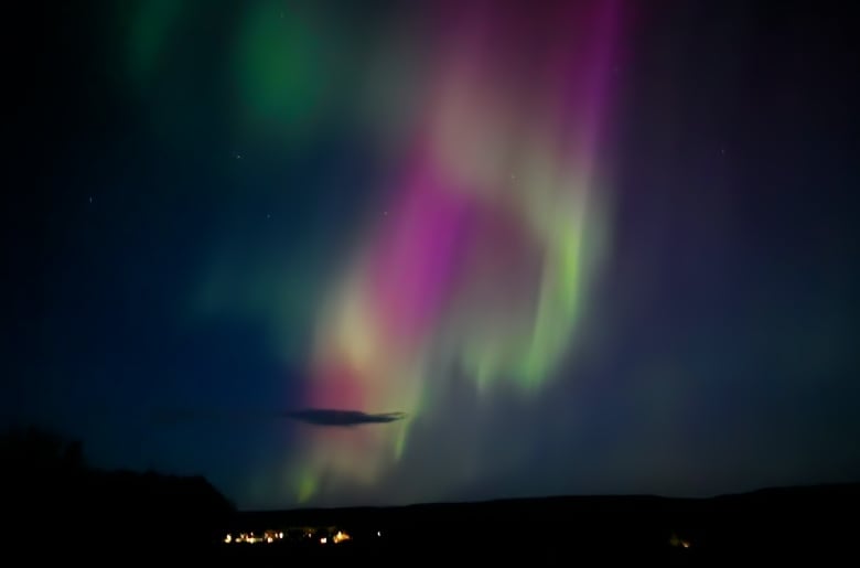 Green and purple lights in a night sky