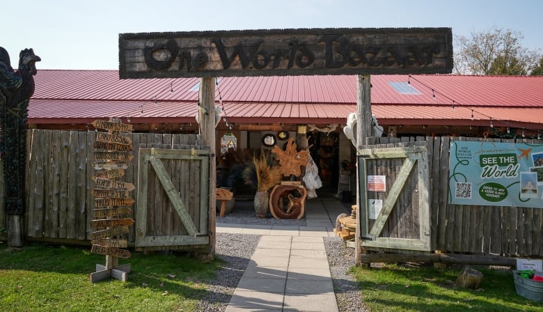 A barn and a wooden sign that says 