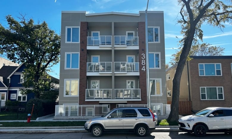 The exterior of a modern four-storey building with street-facing balconies.