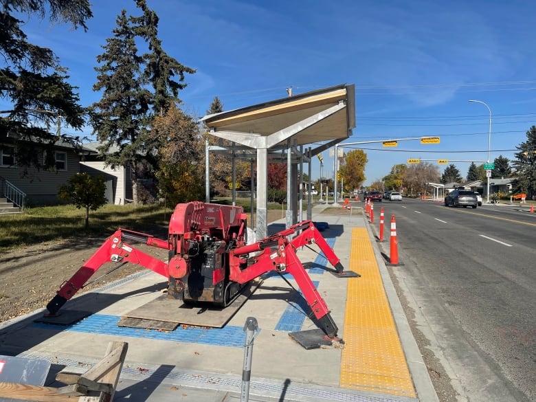 Construction equipment at a bus shelter