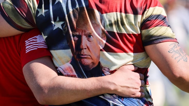 A person wears a shirt featuring a person's portrait.