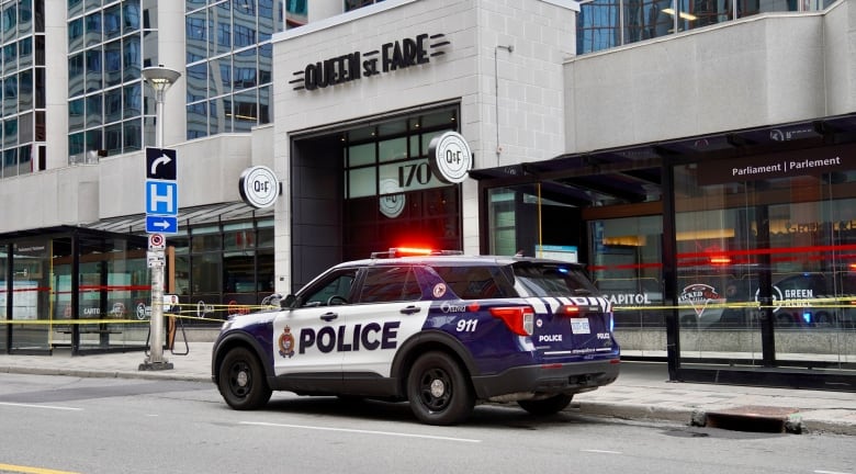 Police tape blocks off a section of sidewalk