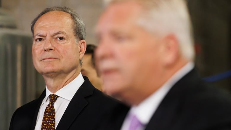 Ontario Finance Minister Peter Bethlenfalvy watches as Ontario Premier Doug Ford speaks to media in Toronto on July 10, 2024.