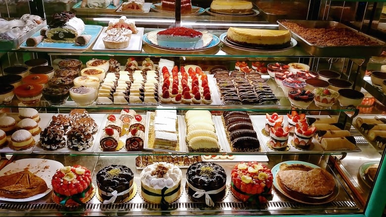 A display of delicious treats in a bakery store counter.