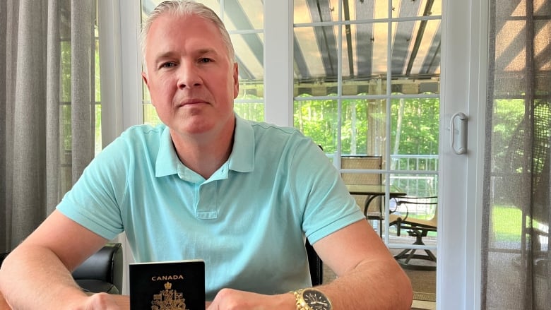 Danny Roy holding his Canadian passport