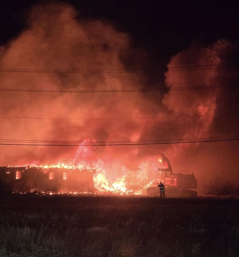 A building is on fire in the dark of night