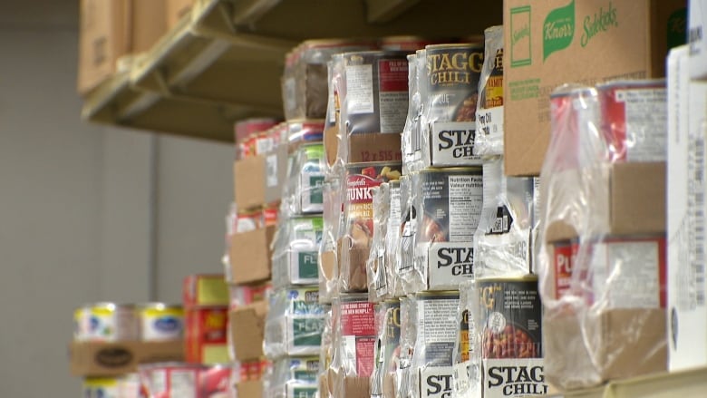 Cans on a shelf are shown