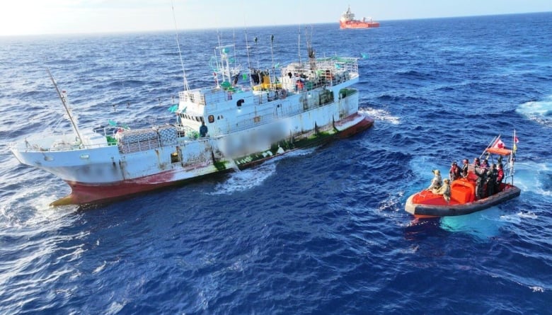 A DFO vessel on the high seas approaches a fishing vessel for an inspection.