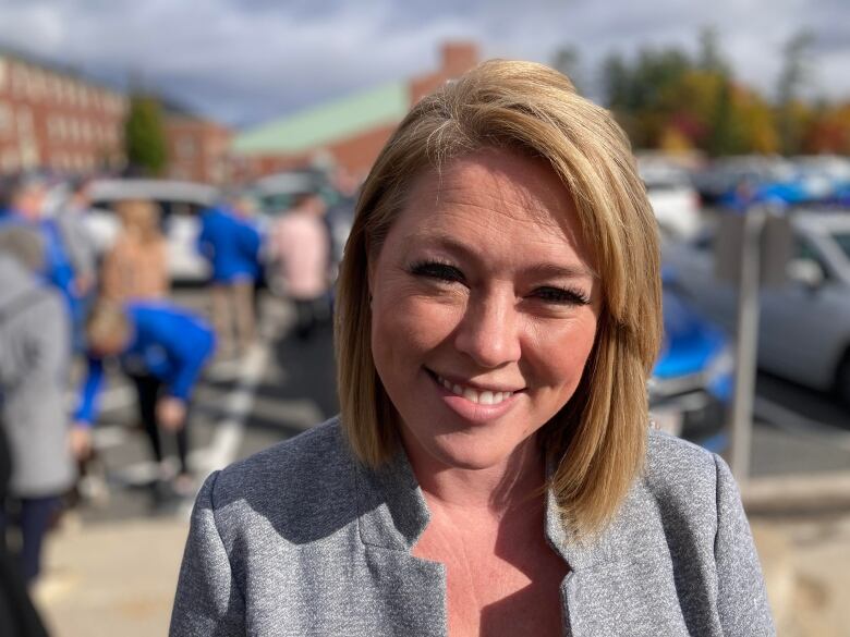 A smiling woman with a blond bob