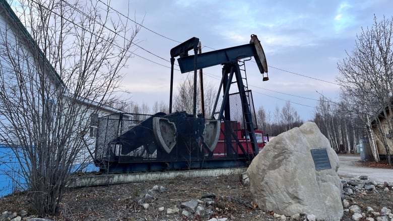 a oil derrick against a clouded sky