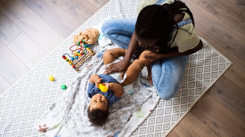 Mom changes her baby's diaper.