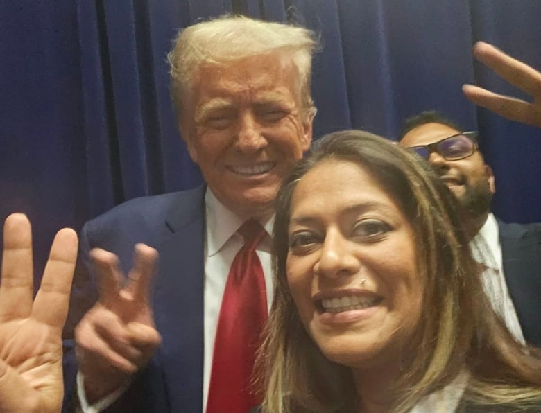 A woman and a man smile for a selfie.