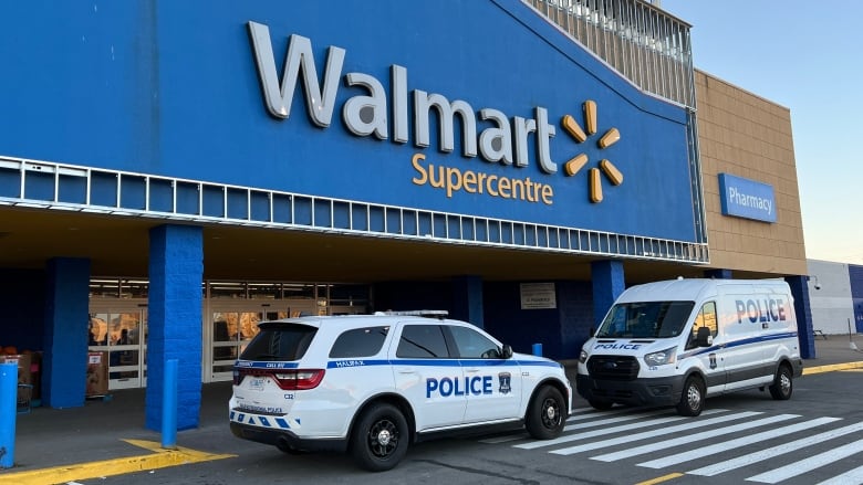 Two white and blue Halifax police vehicles are shown outside of a Walmart.