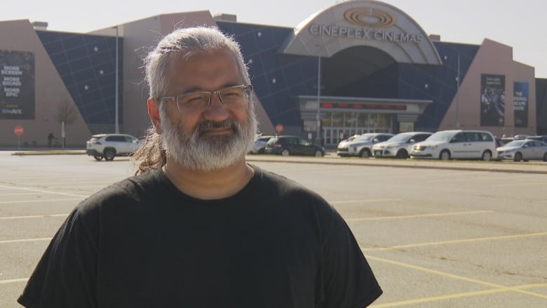 Photo of a man outside a cineplex