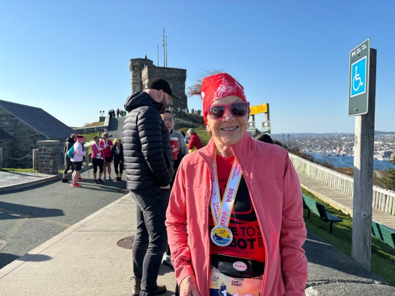 A woman smiles while standing in front of Cabot Tower.