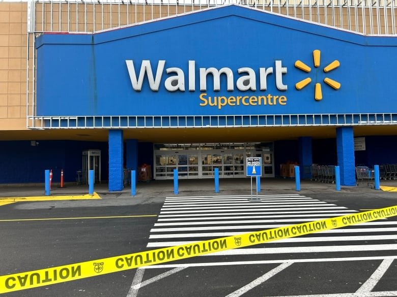 Police tape in front of a closed Walmart. 