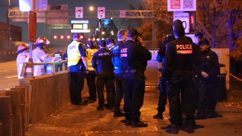 police officers on a bridge.