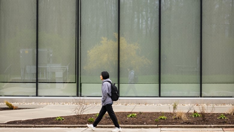 A student walks on the Conestoga College campus in Kitchener, Ont., Saturday, April 27, 2024. 